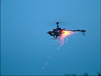 Gas Powered Radio Control Helicopter modified to remotely fire model rockets by Christopher Conte