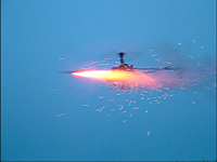 Gas Powered Radio Control Helicopter modified to remotely fire model rockets by Christopher Conte