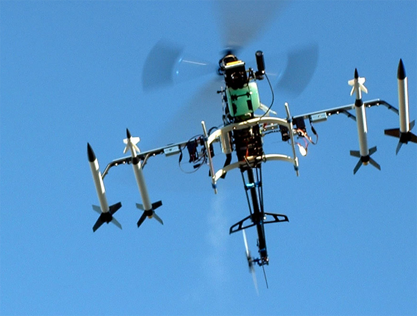 Gas Powered Radio Control Helicopter modified to remotely fire model rockets by Christopher Conte